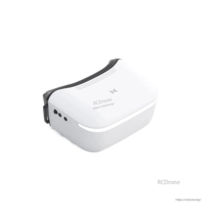 Angled view of white FPV goggles showing side buttons and top vents, with RCDRone watermark on image