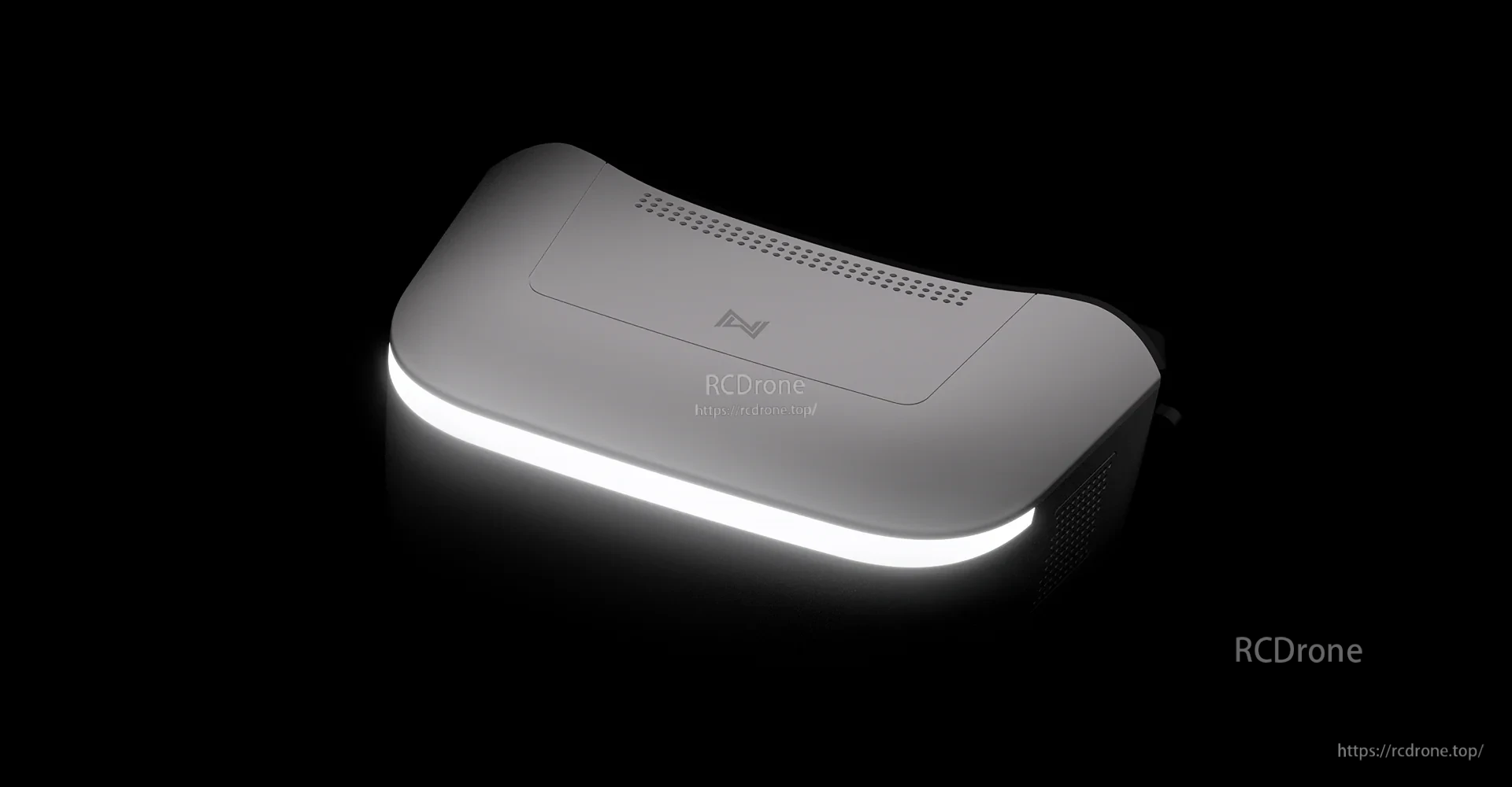 Dark studio shot of goggles with front light bar glowing around the housing