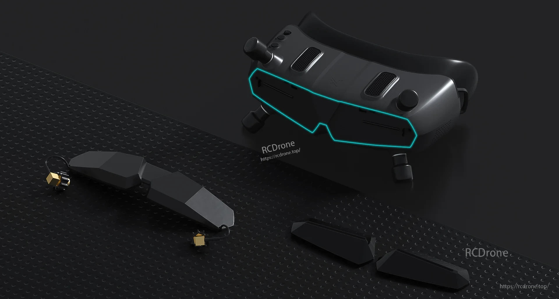Goggles with front cover removed alongside modular cover parts and antenna accessories on a tabletop