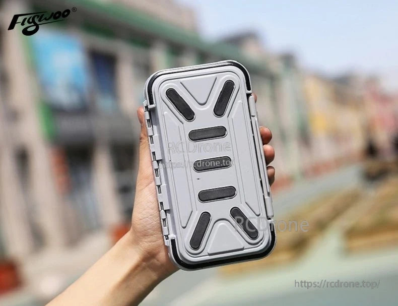 Compact waterproof FPV tool box with rugged gray lid, black seal edge, and side latches in hand