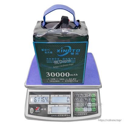XINGTO 14S 30000mAh 10C 51.8V solid-state battery delivers 270Wh/kg power density, weighs 6116.4g, and includes a digital control panel showing detailed specs.