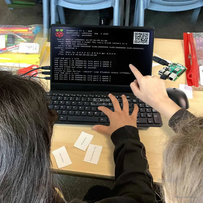Touchscreen monitor in use with Raspberry Pi setup on desk, finger touch input with keyboard and mouse connected