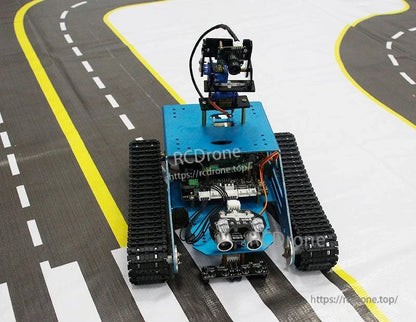 Tracked smart robot car on road track mat with curves and crosswalk markings, top-front view