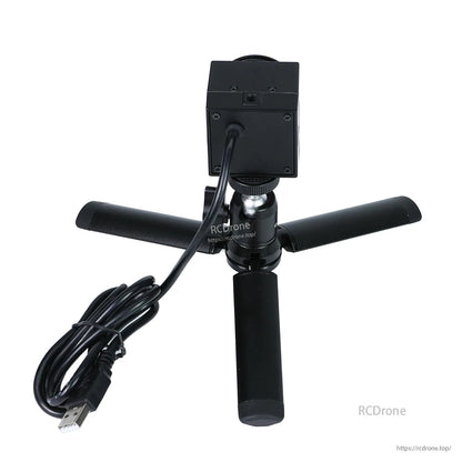 Rear view of camera mounted on tripod with attached USB cable and plug