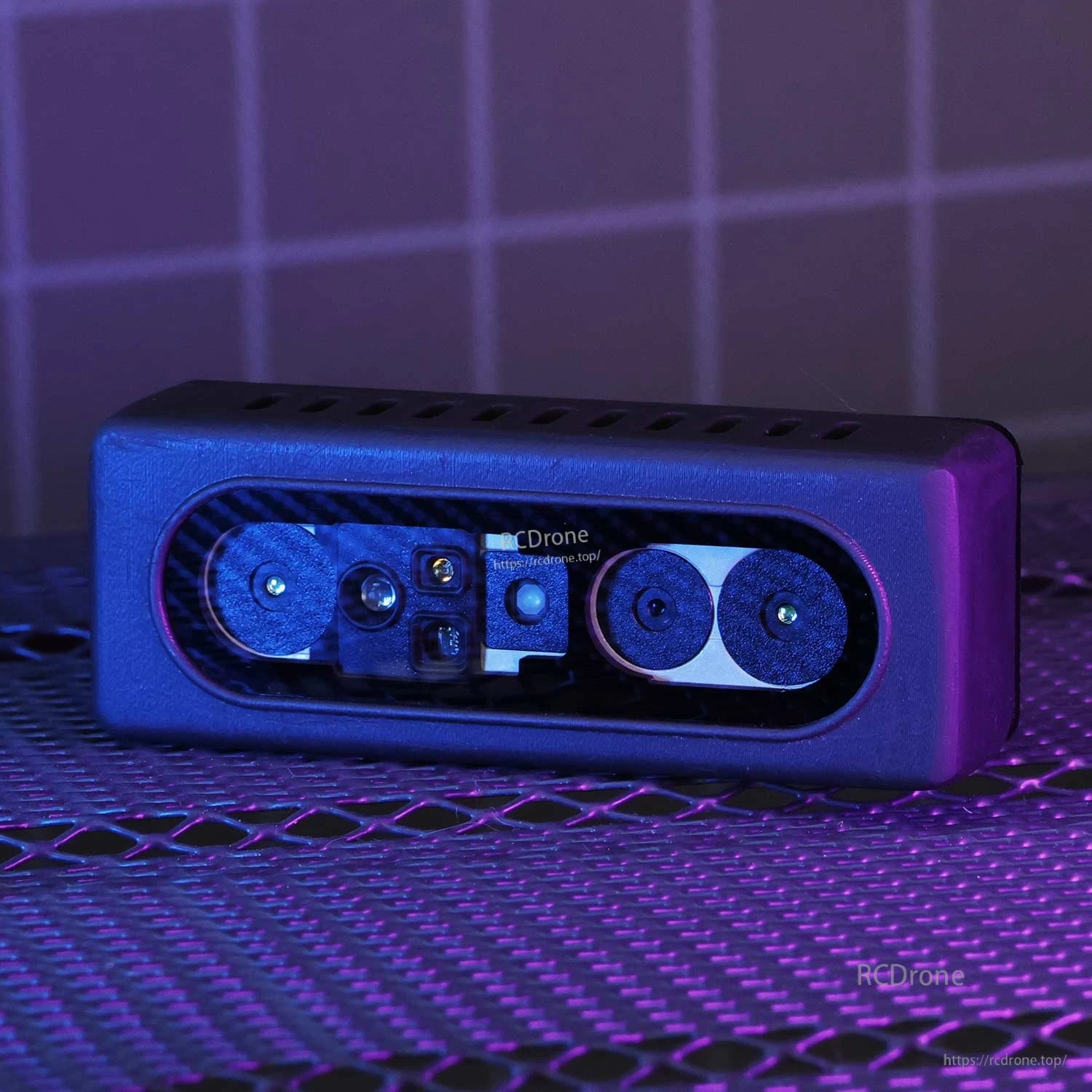 Angled close-up of binocular depth camera module in purple lighting, showing dual lenses and sensor window