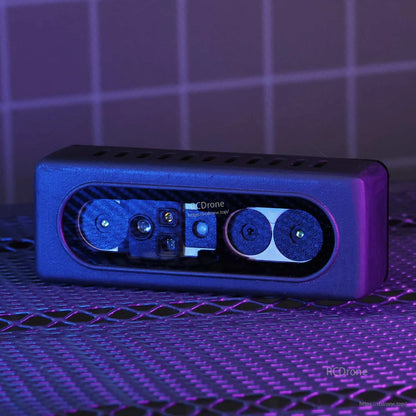 Angled close-up of binocular depth camera module in purple lighting, showing dual lenses and sensor window