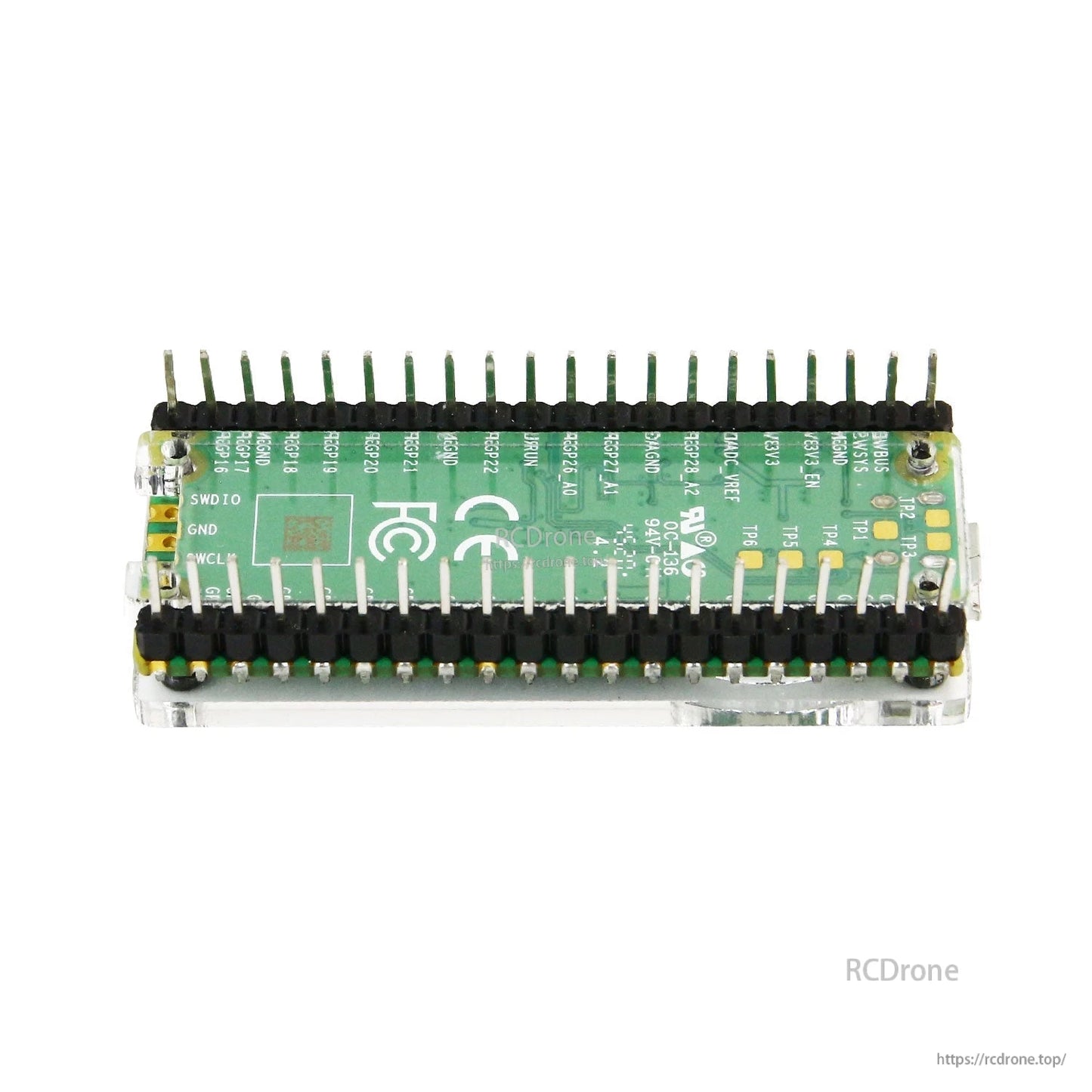 Rear view of board in acrylic case showing pin header rows and underside visibility through clear panels