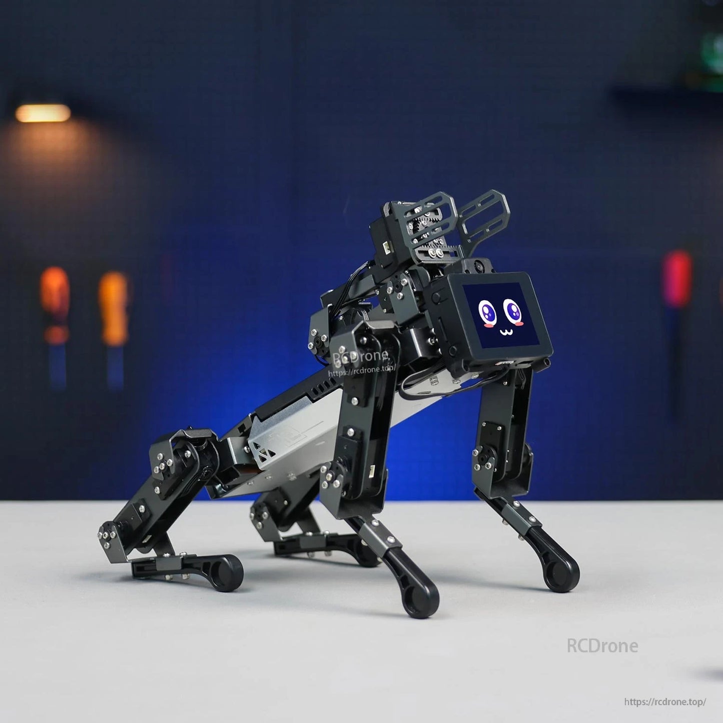 Yahboom DOGZILLA-Lite 15DOF quadruped robot side view on tabletop with front screen face display