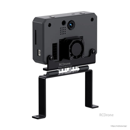 Rear angle on U-shaped stand showing lens area, fan bracket, and side slot opening