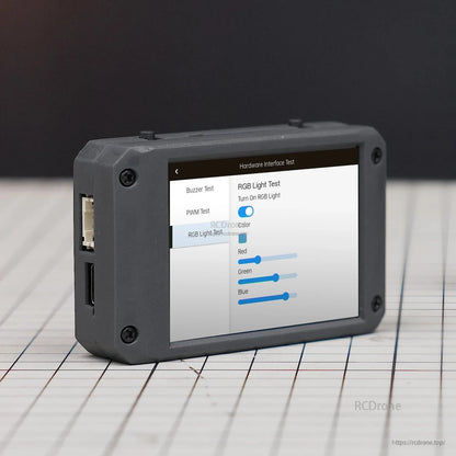 Side angle view of module showing 2.4-inch touchscreen running RGB light test sliders and side ports