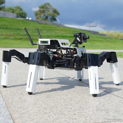 Side view of assembled Muto S2 hexapod robot on pavement showing camera mount and antenna modules