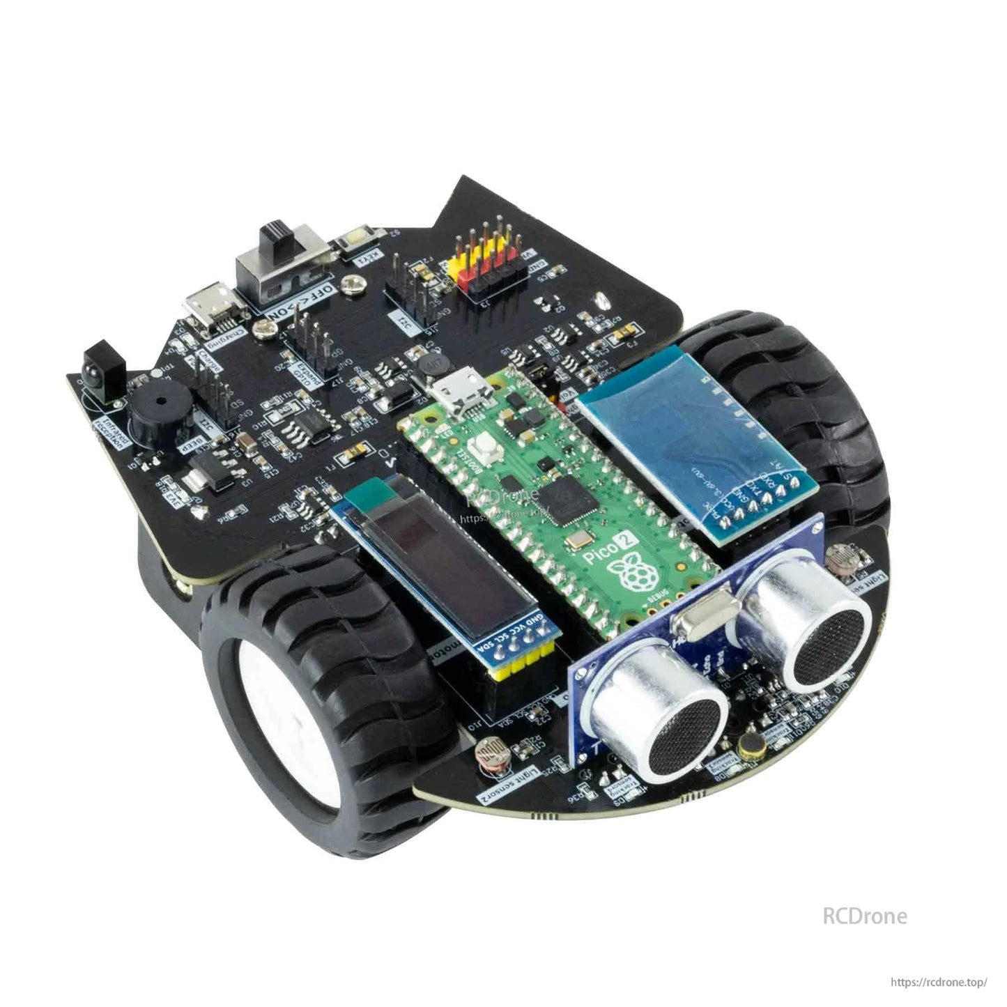 Close-up top view of robot car chassis showing Pico board, OLED display module, and ultrasonic sensor