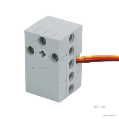 Gray building block servo module front view with output shaft opening and three-wire lead