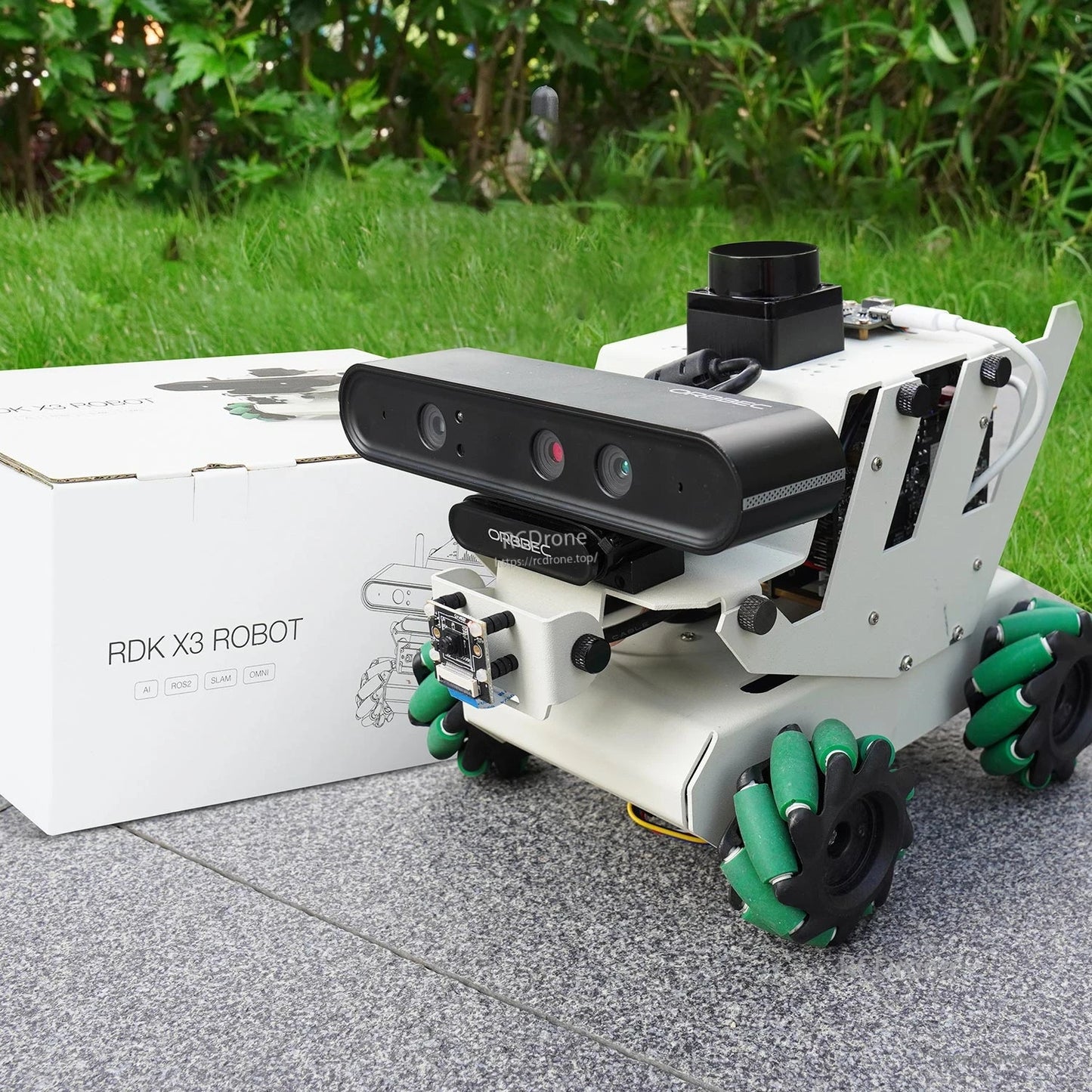 Yahboom RDK ROS2 Robot shown outdoors beside RDK X3 ROBOT retail box packaging