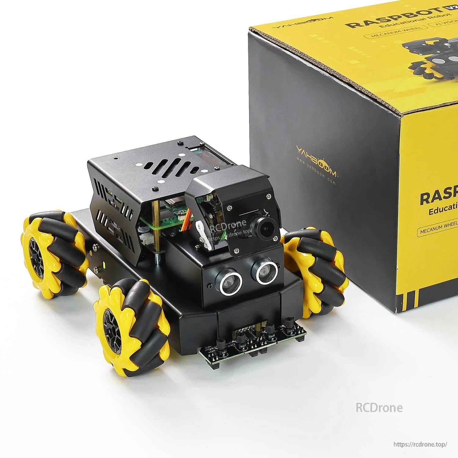 Yahboom Raspbot V2 robot car next to retail box, front view showing camera and ultrasonic sensors
