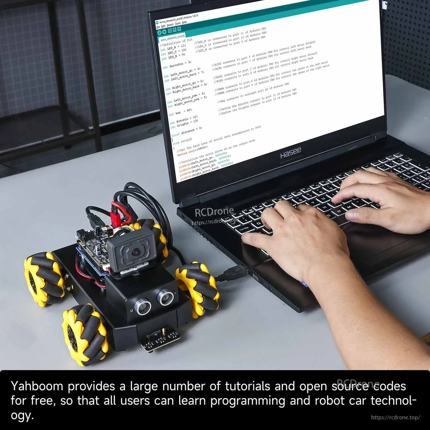 Robot car connected to laptop for programming, Arduino IDE code on screen