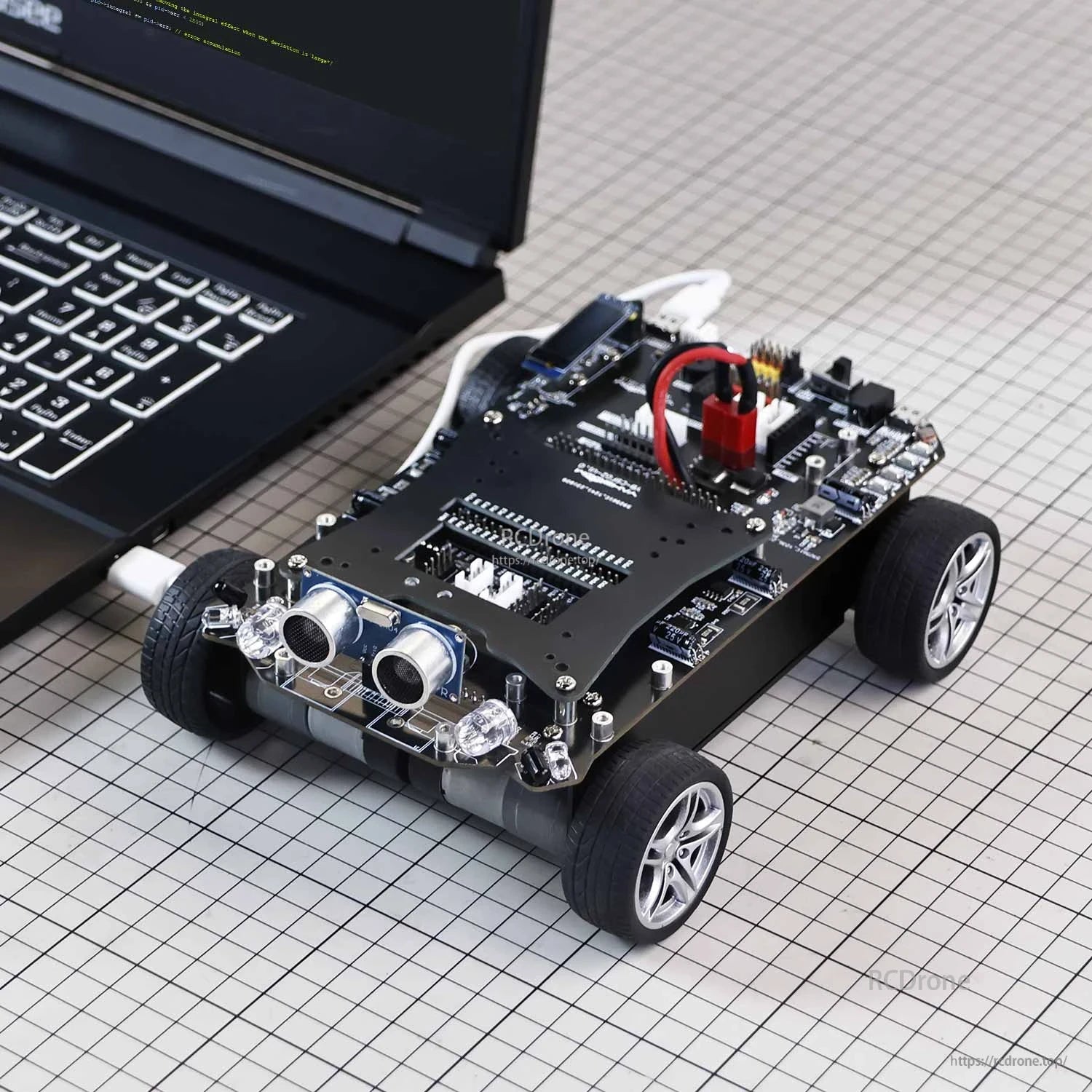 Smart robot car development board on 4-wheel chassis with ultrasonic distance sensor module and USB connection