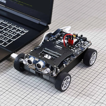 Smart robot car development board on 4-wheel chassis with ultrasonic distance sensor module and USB connection