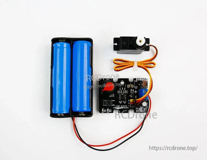 Top-down wiring demo with battery pack, PWM controller board, and small servo motor connected by 3-wire cable