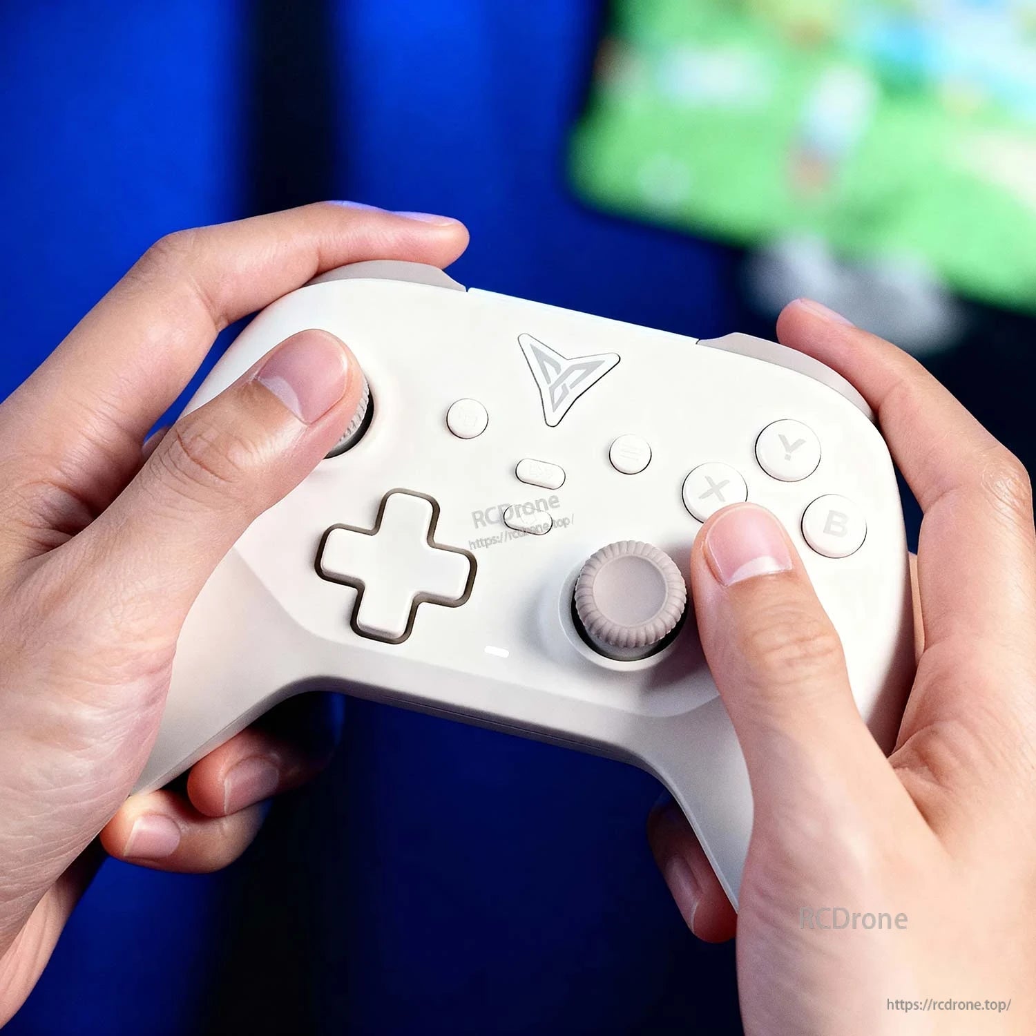 Close-up of hands holding the white controller, showing ABXY buttons, D-pad and dual joysticks