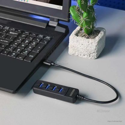 USB 4-port hub connected to a laptop on a desk setup