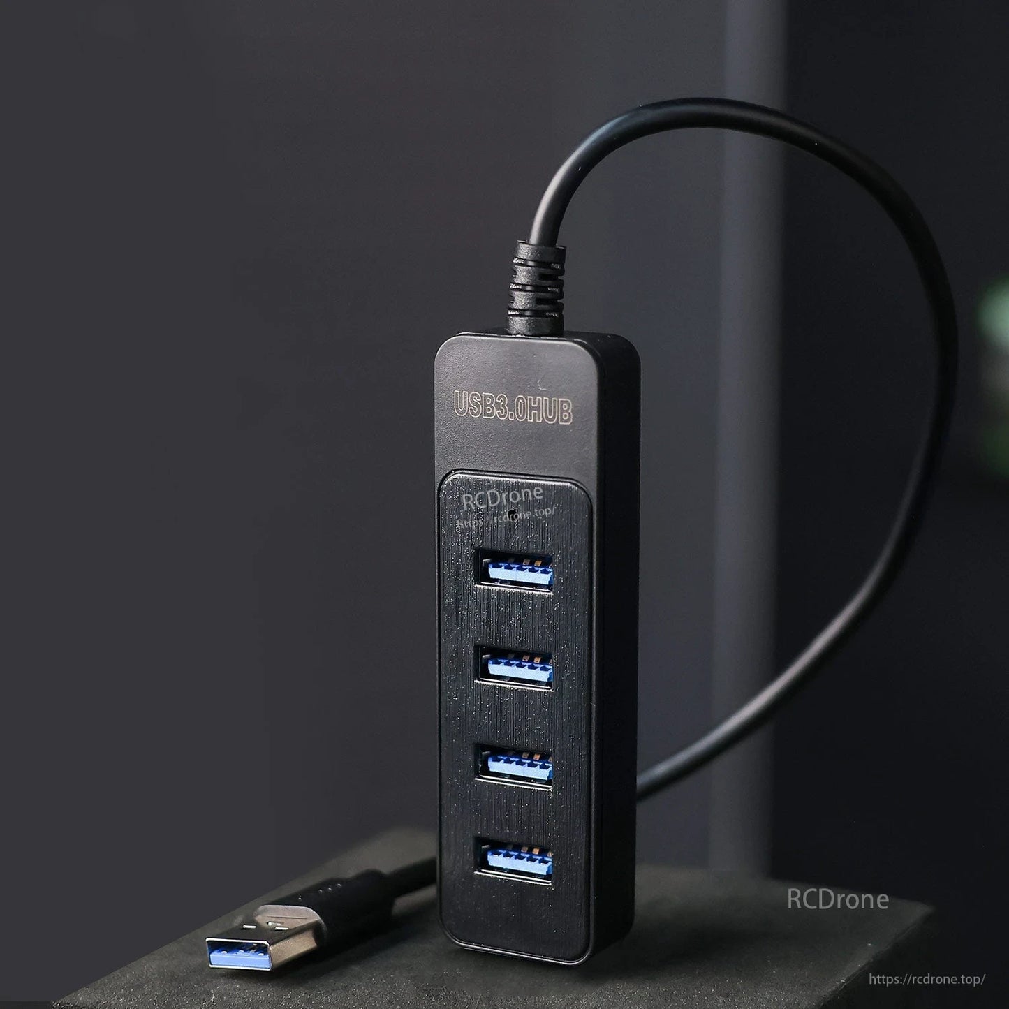 Vertical view of the 4-port USB-A hub showing blue USB 3.0 ports and cable entry