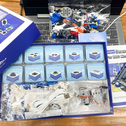 Unboxed Yahboom micro:bit sensor kit in tray with labeled modules, building pieces, cables and instruction booklet