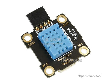 Angled close-up of sensor module with blue DHT11 housing and VCC/OUT/NC/GND header pins