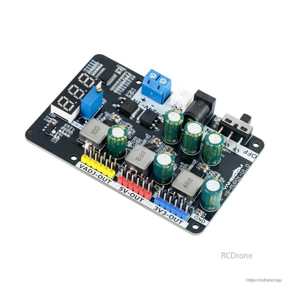 Angled view of DC-DC step-down regulator board showing display, DC jack, switch, and VADJ/5V/3.3V headers
