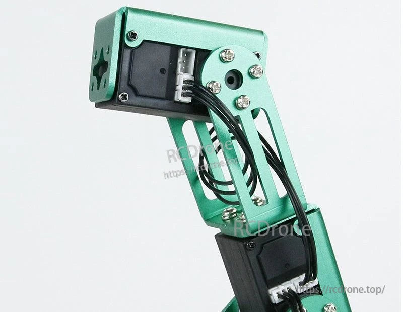 Serial bus smart servo mounted in green metal robotic arm joint, cable routing detail