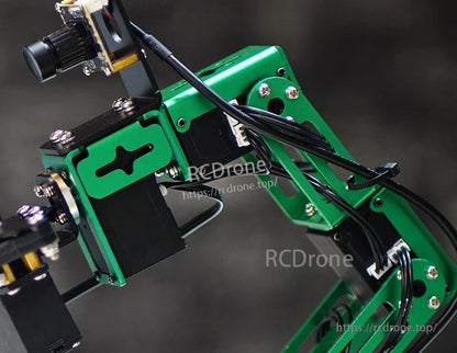 Close-up of smart servo installed on green robot arm bracket with connected harness
