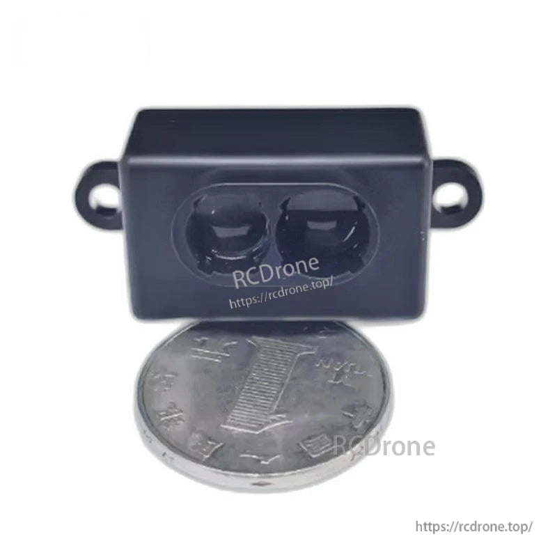 LiDAR module size reference next to a coin, front face with two optical windows