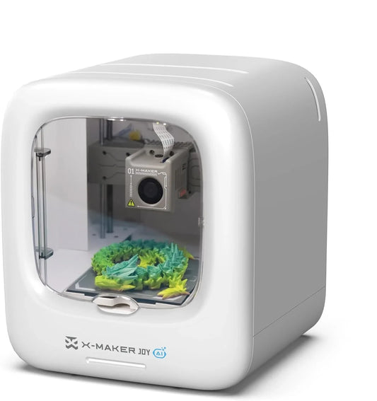 White X-MAKER JOY enclosed 3D printer shown from the front with colorful spiky printed models on its build plate.
