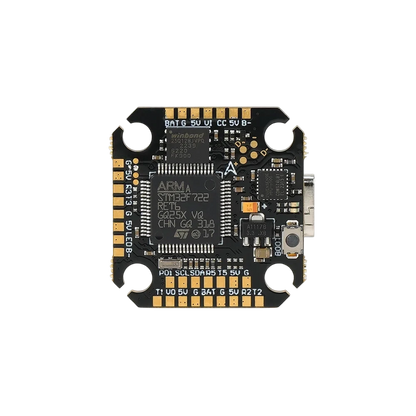 Close front view of the flight controller showing the STM32F722 processor, USB-C connector, boot button, and labeled solder pads.