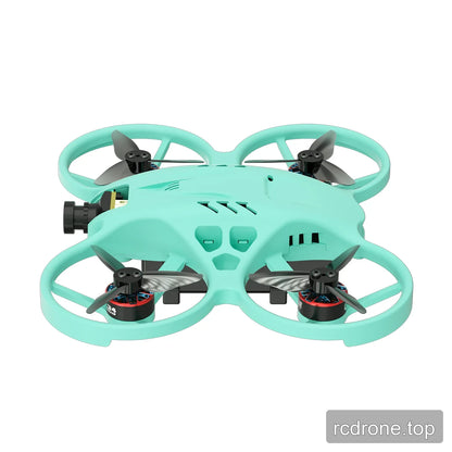 Low side view of the mint green ducted FPV drone with its front camera, four propellers, and enclosed frame.