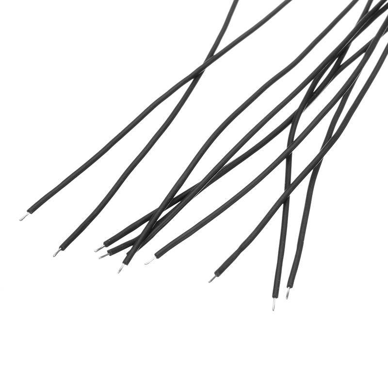Black silicone wire leads with stripped tips, close-up of multiple wires on white