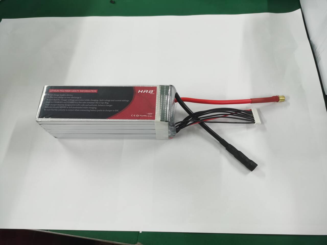 Side view of HRB 8S LiPo battery showing warning label and main power lead with balance connector