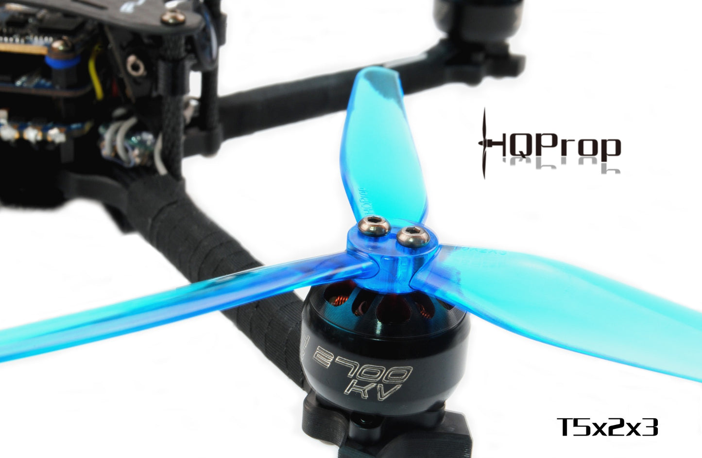 HQProp T5X2X3 tri-blade prop installed on FPV drone motor, close-up of hub and blades
