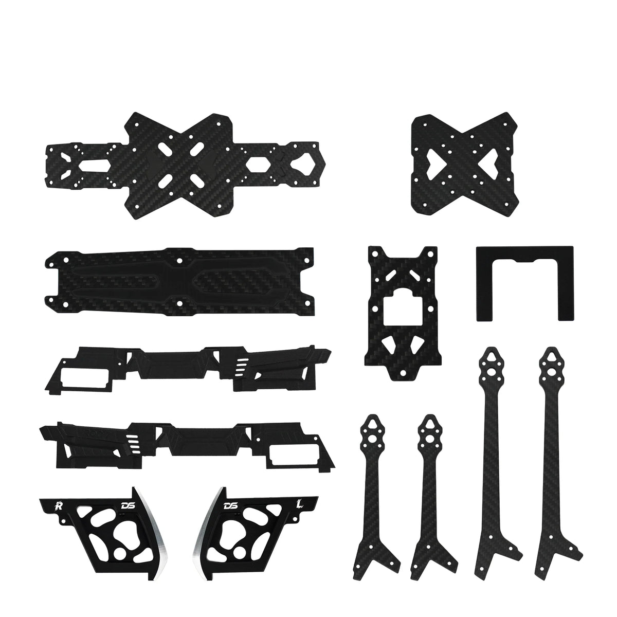 Assorted black carbon-fiber-pattern FPV drone frame plates, arms, side panels, and small mounting pieces.