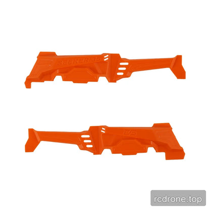 Two orange molded plastic frame parts shown from opposite sides, with SEEKER 35 and DS markings plus vent-like slots.