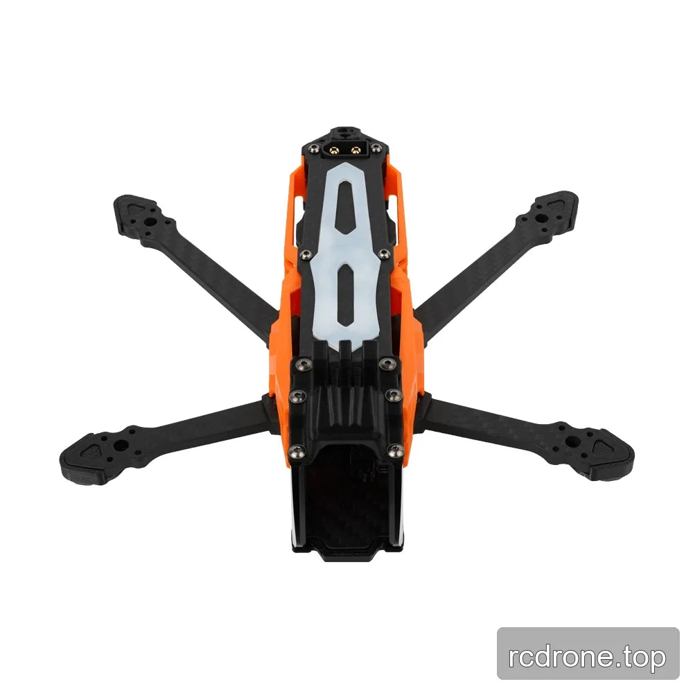 Top-down view of the orange and black DeepSpace SEEKER35 FPV frame, showing the pale slotted top plate and four arms.