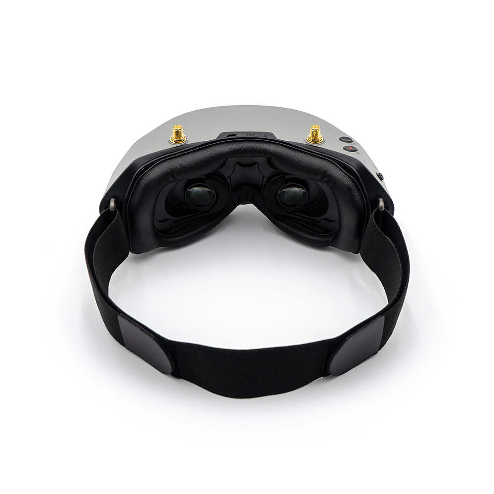Rear interior view of goggles showing dual eyepieces, face foam padding, and head strap attachment