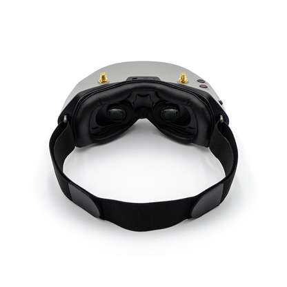 Rear interior view of goggles showing dual eyepieces, face foam padding, and head strap attachment
