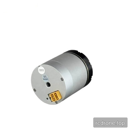 Rear view of the silver cylindrical motor with a yellow two-pin connector, central opening, and QC Passed label.
