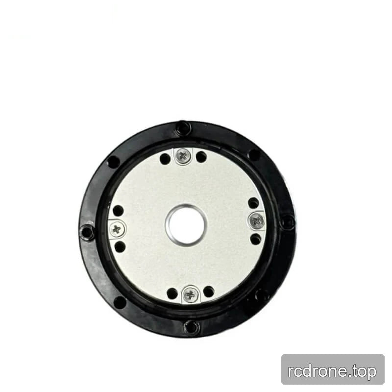 Close front view of the motor showing the circular metal plate, center opening, screws, and surrounding mounting holes.
