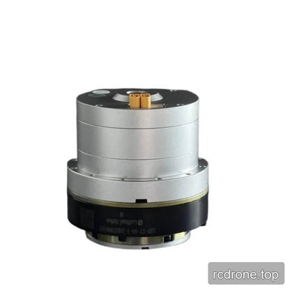 Rear view of the cylindrical motor showing its silver casing, black lower section, and twin yellow electrical terminals