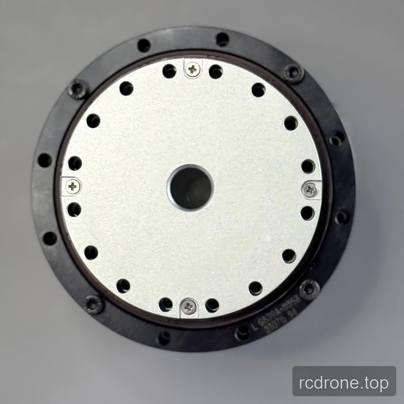 Motor face with central bore and circular mounting-hole pattern