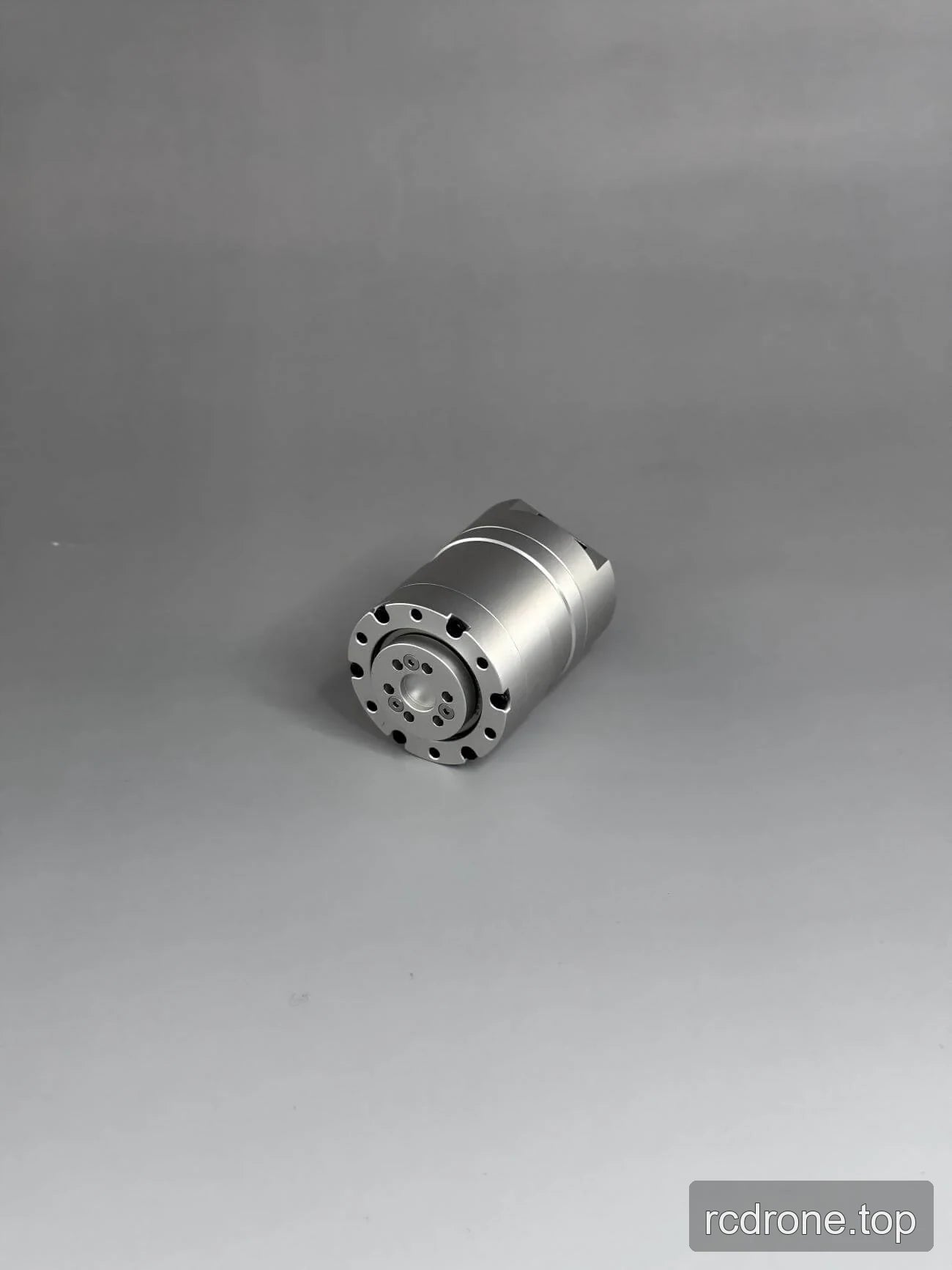 Angled view of a silver cylindrical motor with circular mounting face