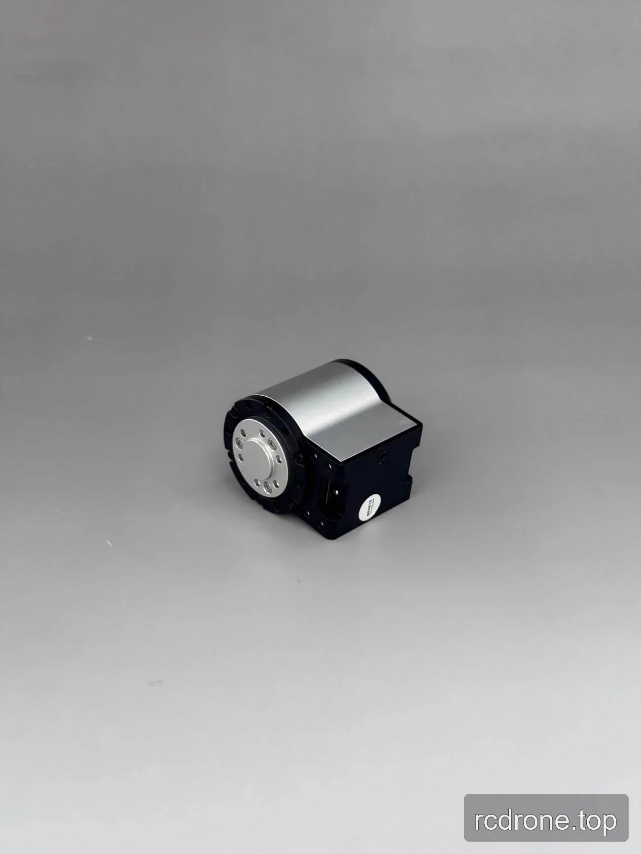 Angled view of compact motor assembly with circular mounting face
