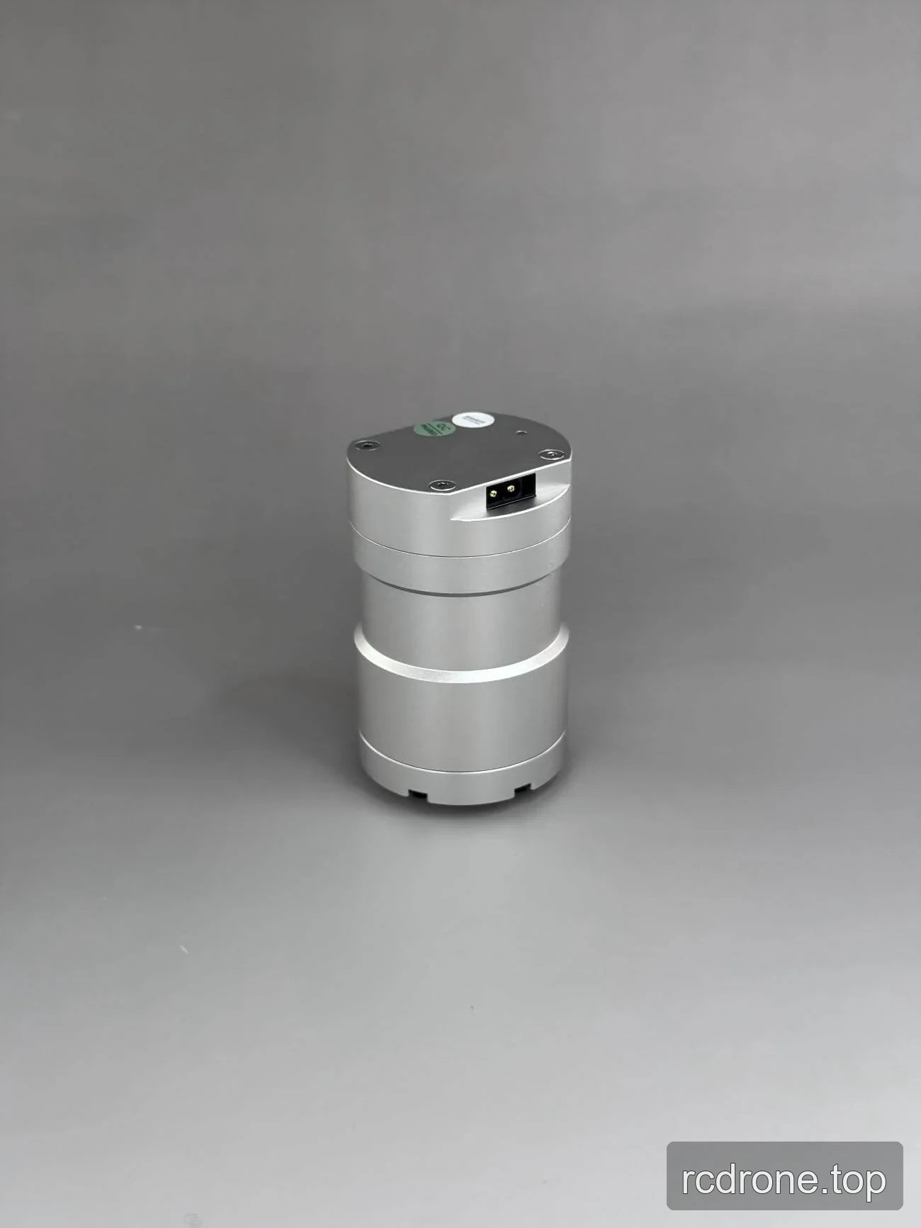 Silver stepped cylindrical motor housing with upper connector